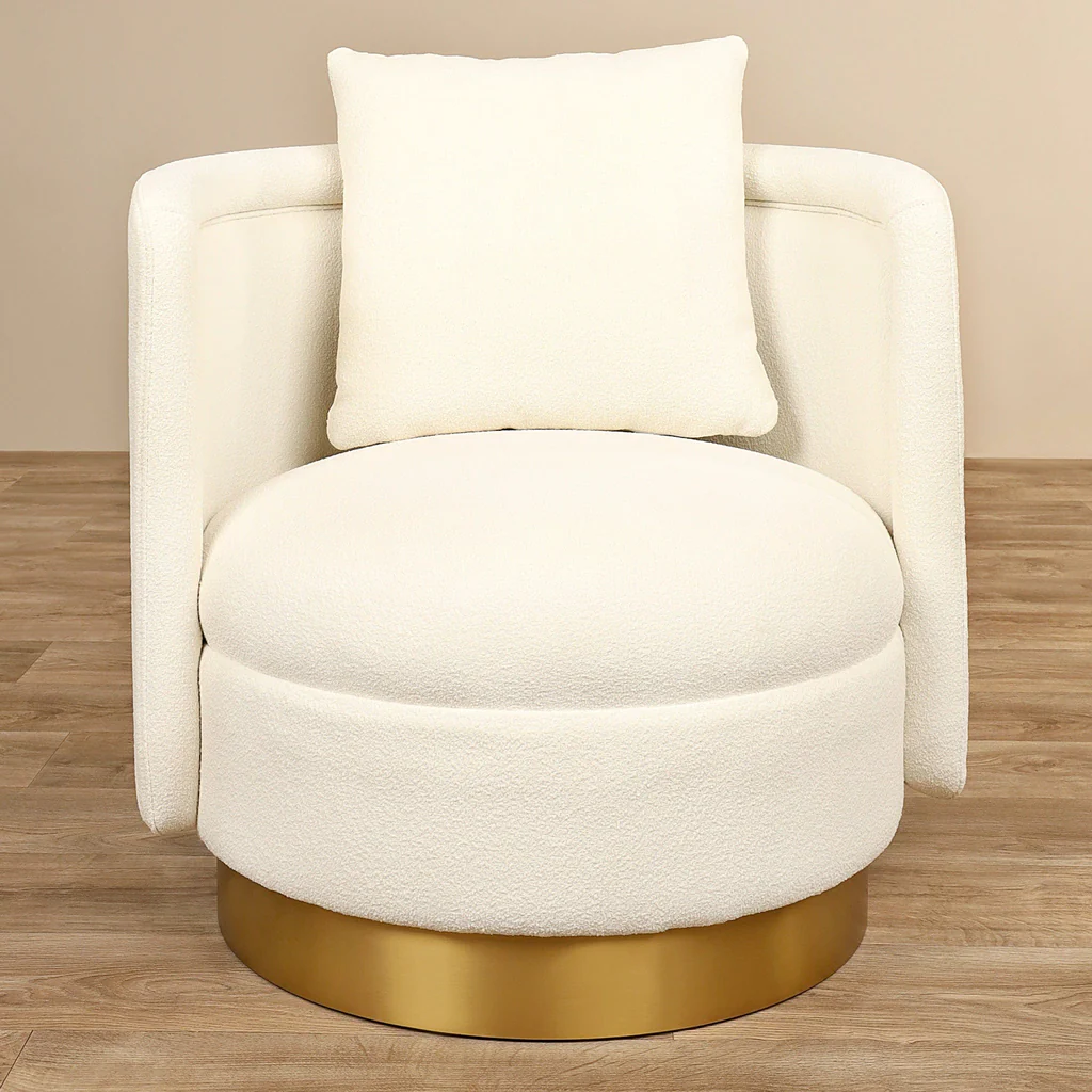 Sculptural boucle accent chair with metallic base and plush cushion styled in boutique interior