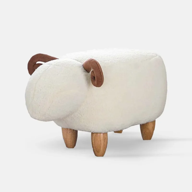 Plush sheep-shaped stool with curved brown horns and wooden legs.