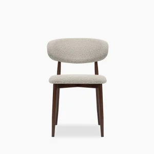 Dining chair with walnut-effect wooden legs and cream boucle upholstered seat and backrest.