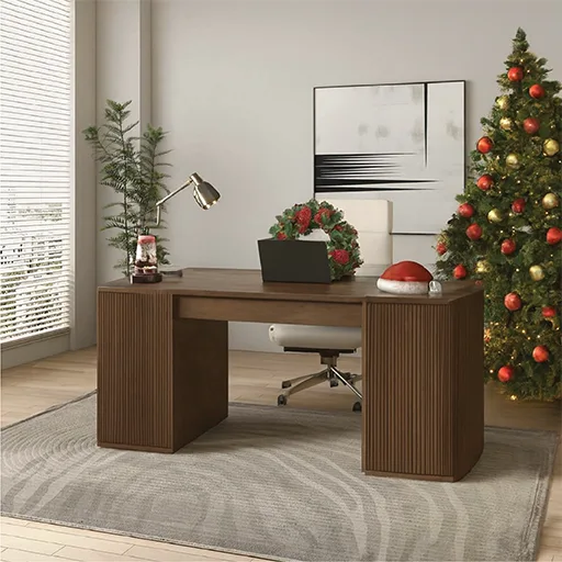 A workspace with a laptop on a desk, complemented by a cheerful Christmas tree in front, enhancing the office decor.