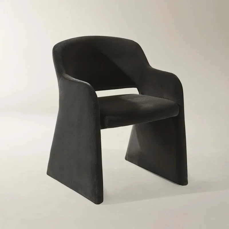 Aurum Flow Chair with sculptural curved design and warm metallic accents for modern interiors.
