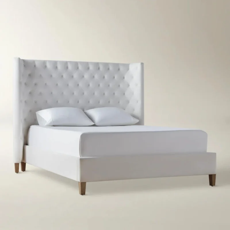 Aurelle Bed with diamond‑tufted headboard and cream upholstery for modern bedroom interiors