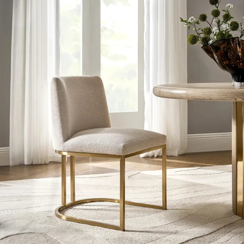 Lustra Frame Chair with beige upholstery and gold metal legs for modern interiors