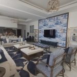 Blue accents and bold patterns bring harmony and elegance to this expansive living and dining space. Spacious living room with beige sofas, blue-patterned armchairs, tufted ottomans, scenic mural wall, and marble flooring in a luxurious modern interior.