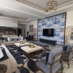 A harmonious blend of classic elegance and modern comfort defines this blue-toned living space. Luxurious living room with blue and white mural wall, marble flooring, multiple seating options, and elegant chandeliers in a modern-classic interior.